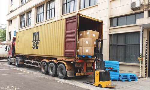 Cartons being loaded into a shipping container outside the DIYASI factory